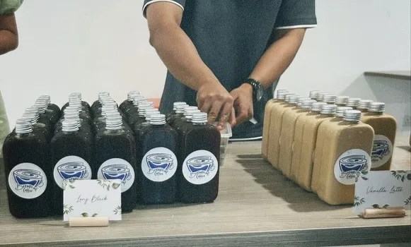 Rows of bottled long black and vanilla latte with Brewprint labels